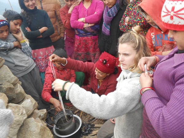 Simone Bodmer-Turner demonstrating candle making to women