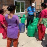 women making sanitizer