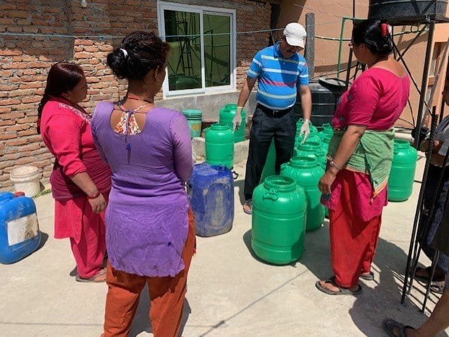 women making sanitizer