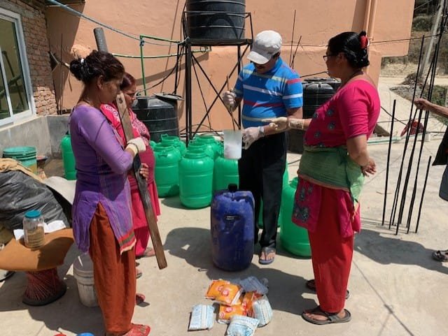 women making sanitizer