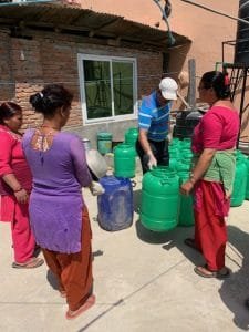 women making sanitizer