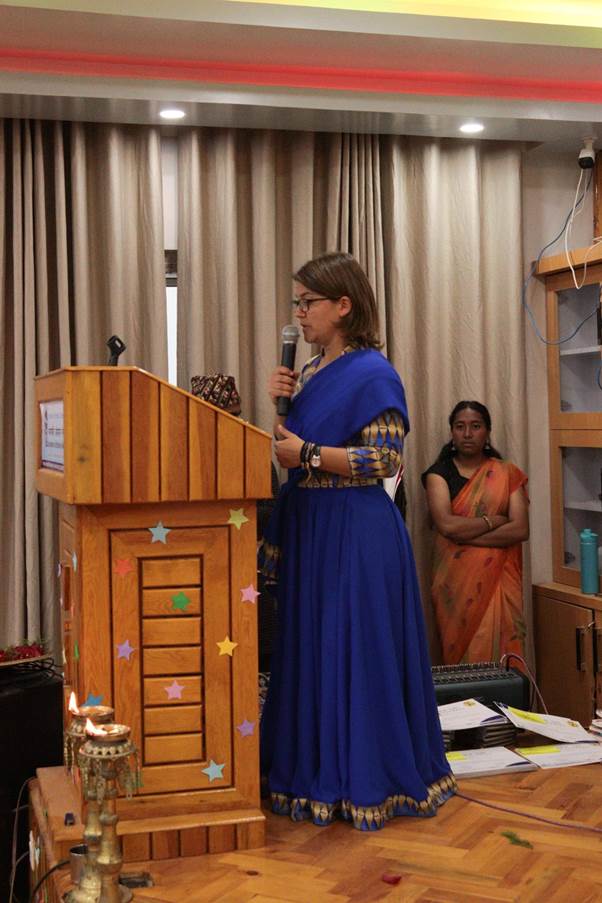 Eszter Boros grabs the microphone to announce the winners of the Nature Journaling Exhibition